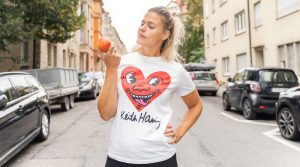 Sara Dahme mit Apfel in der Hand auf der Straße