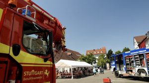 Blick zwischen Feuerwehr- und THW-Fahrzeug auf Festzelt vor der Kelter